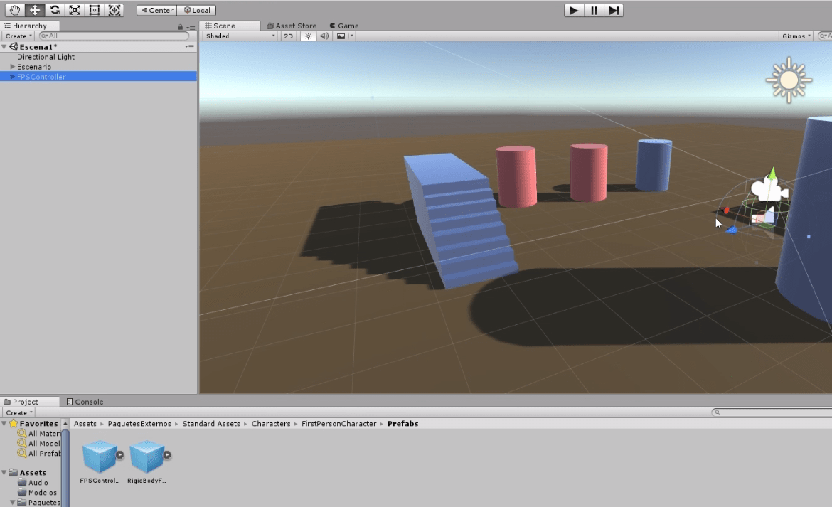 programa unity3d. se observa una escena con suelo marrón, una escalera azul, dos cilindros rojos y dos cilindros azules.